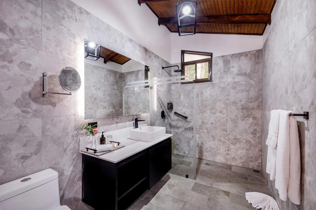 The Master Suite bathroom, microcement walls, a double basin and a walk-in shower